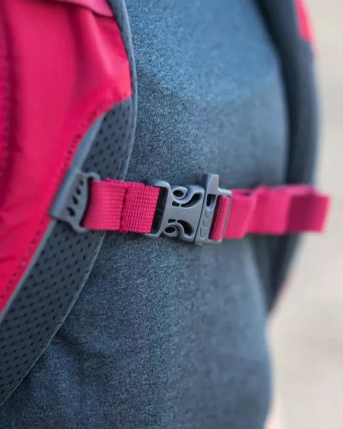 תרמיל Outdoor Revolution Makalu 28 ליטר אדום, תקריב על רצועת חזה עם אבזם קליפס ומשרוקית חירום בין הכתפיות