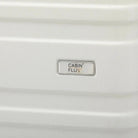 תקריב לוגו CABIN FLUX על מזוודה קשיחה Celine בצבע שמנת, חומר ABS, סימן מסחר רשום