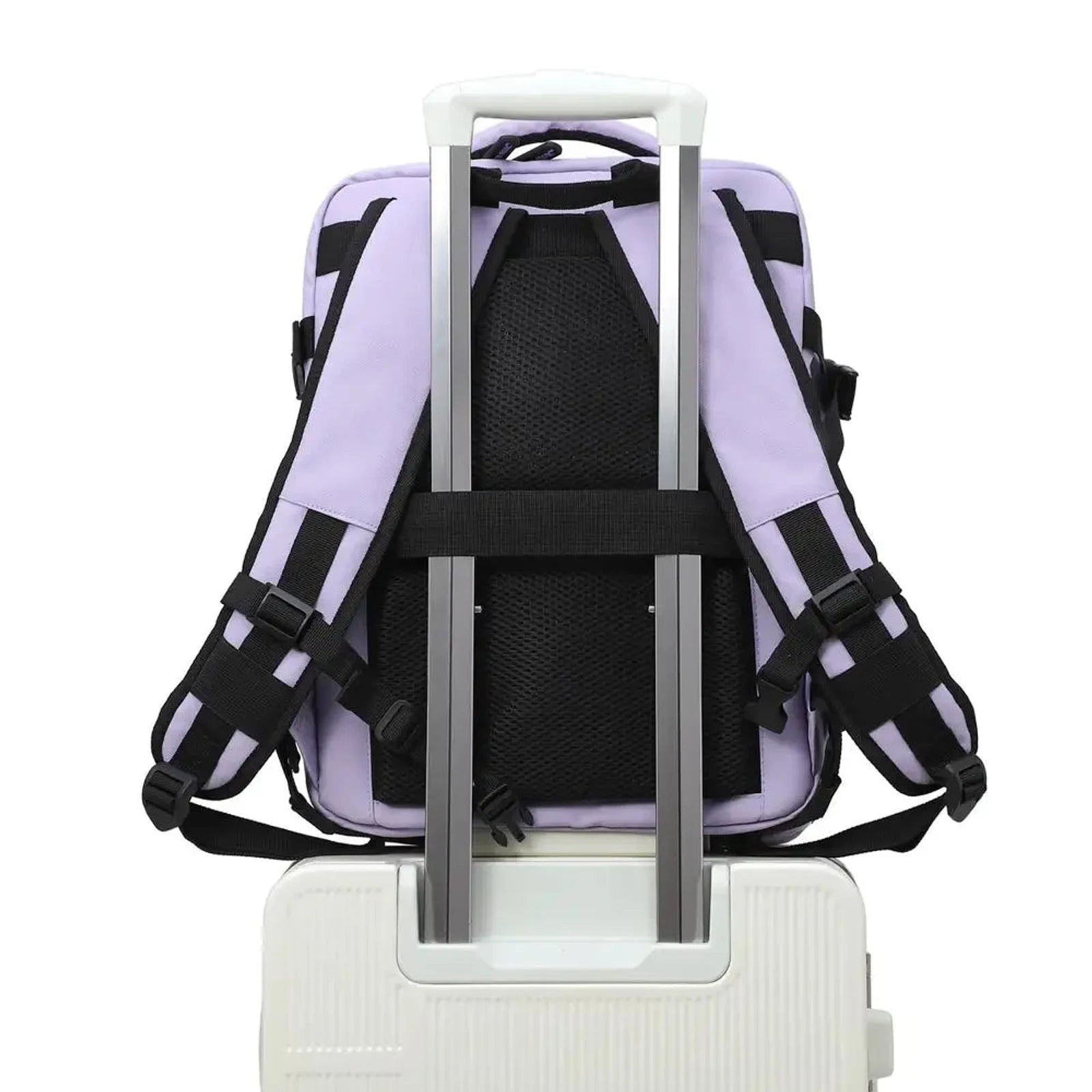 תיק עליה למטוס CABIN FLUX Iconic Pastel בצבע לילך עם רצועת גב מחוברת על ידית טרולי של מזוודה, מבט מאחור