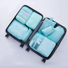 ארגוניות CABIN FLUX בצבע טורקיז בתוך מזוודה פתוחה עם 7 חלקים מסודרים לחיסכון מקום