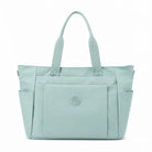 תיק צד יומיומי COOLPASE Carry Travel Tote בצבע מנטה - מבט קדמי, מתלבש על מזוודה עם כיסים מרובים