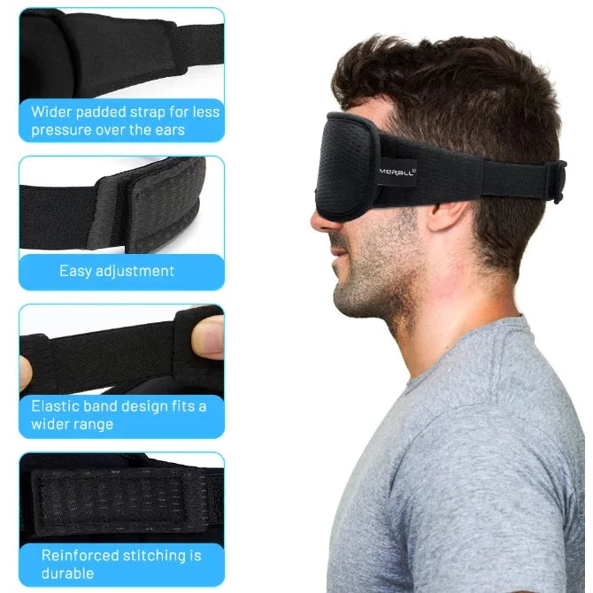 גבר עונד כיסוי עיניים 3D שחור מקצף פוליאסטר מאוורר עם רצועה מתכווננת, חוסם אור לשינה עמוקה