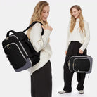 תיק גב נסיעות LOVEVOOK Urban Voyage 35L נשי בצבע שחור על גב של אישה, מבט צידי ונשיאה ביד