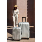 זוג מזוודות קשיחות Samsonite C-lite Spinner בצבע לבן פנינה, דגם גדול 28 אינץ' ודגם קבין, סצנת נסיעות