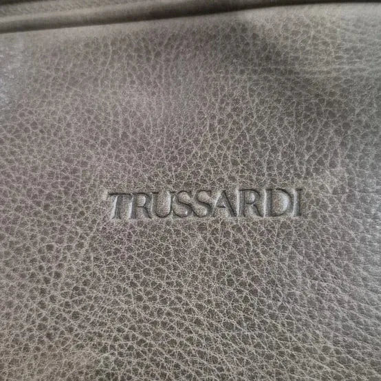 תקריב של לוגו TRUSSARDI מוטבע על עור איטלקי אמיתי בתיק הדגם Vittorio Roma, מעיד על איכות המותג האיטלקי